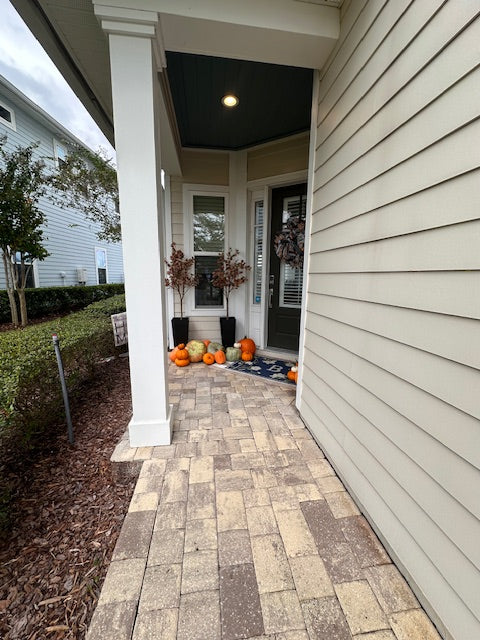 Front porch with decorative pumpkins and a stone pathway in JacksonvilleFL