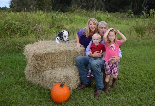 2 large Halloween Hay Bales shown with happy family making memories
