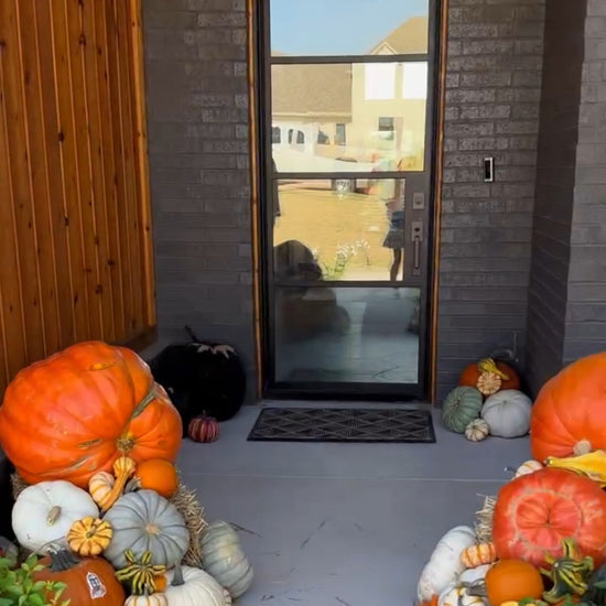 Video of many pumpkins placed around a home in a grand way
